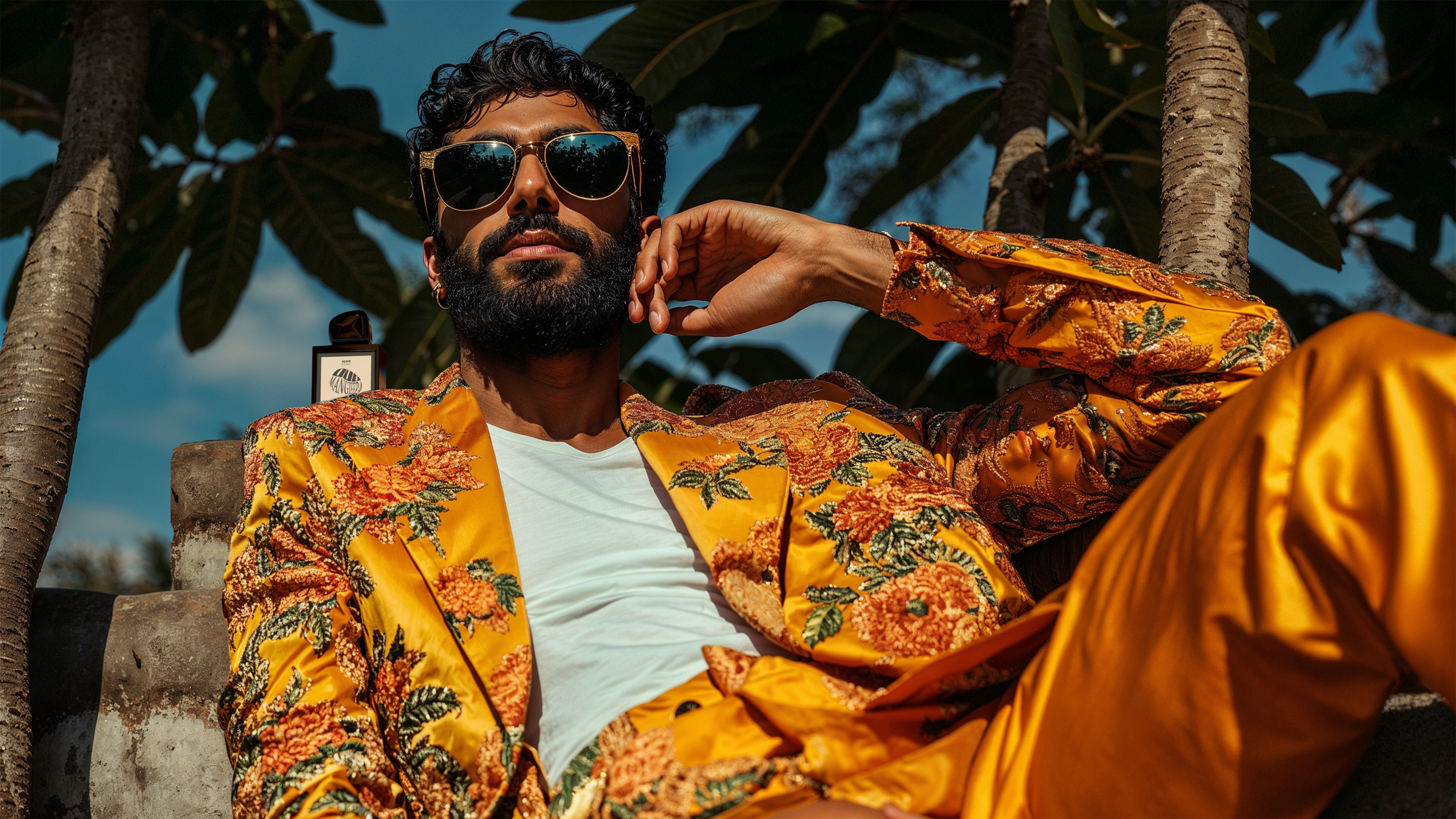 Oud Mangifera Rahasya fragrances model wearing sunglasses and looking out into the distance on a summer day in India