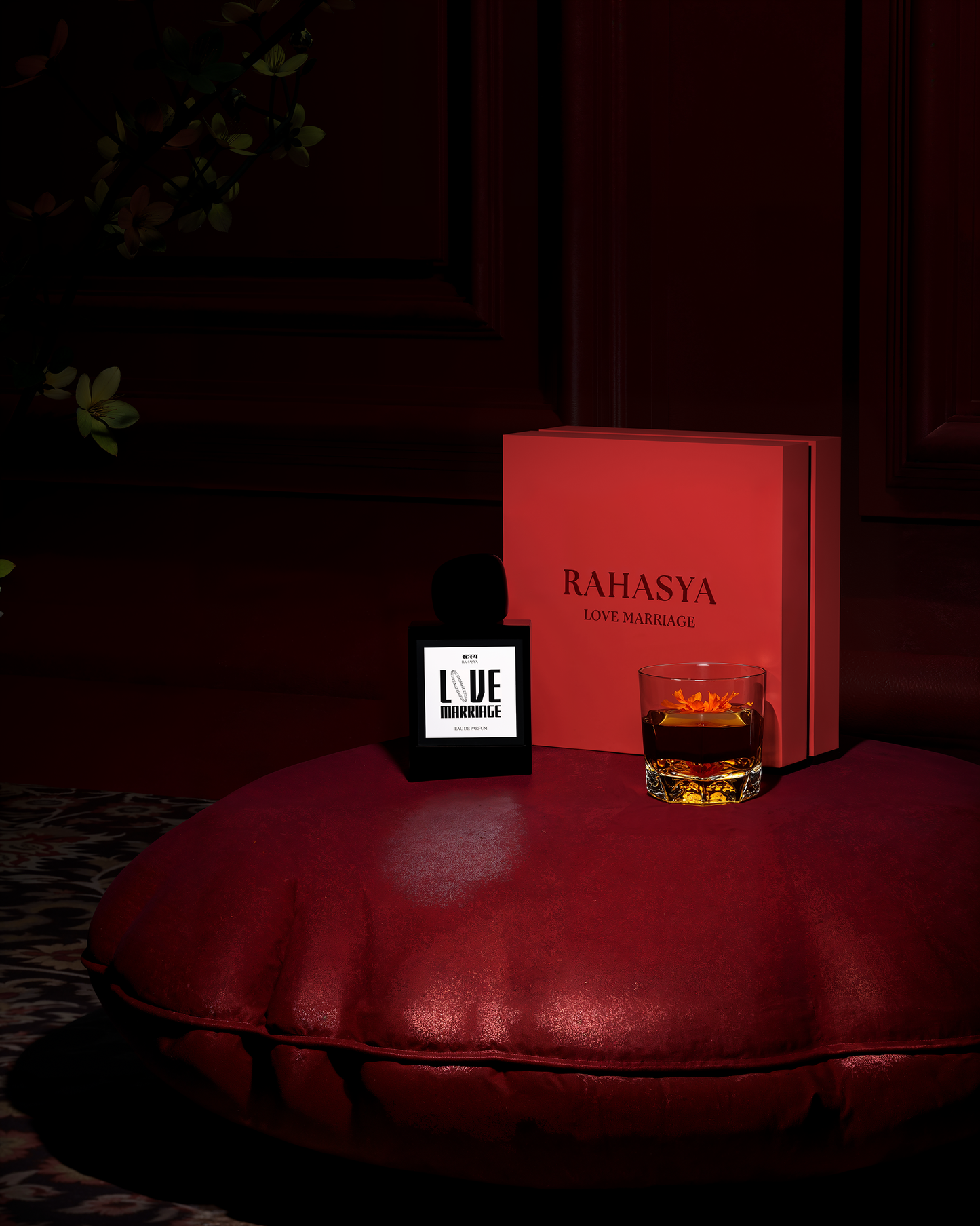 Close up shot of Rahasya Fragrances Love Marriage perfume bottle and packaging on top of a red luxury cushion